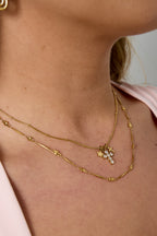 Necklace with cross and star charms