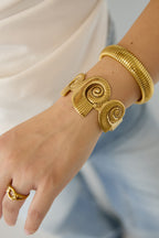 Cuff statement bracelet with spiral shells