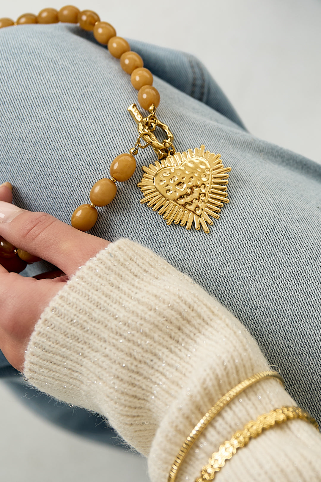 Bead necklace with front closure charm