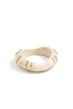Resin bangle bracelet with studs in a striped pattern