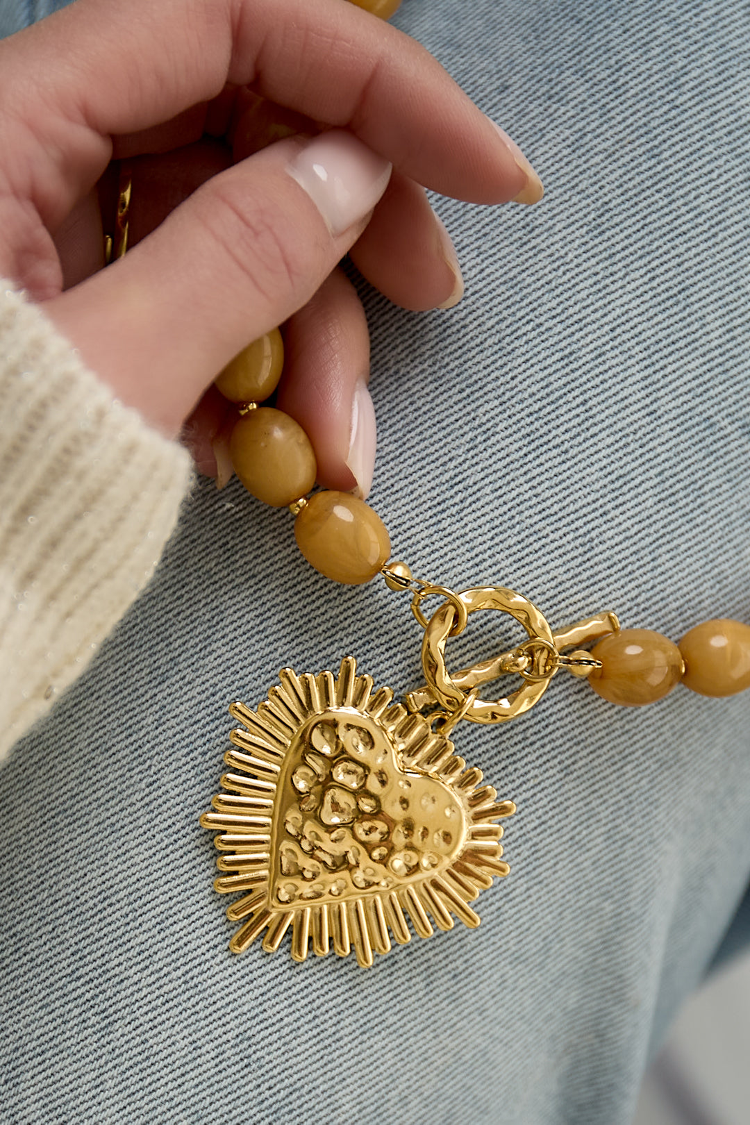 Bead necklace with front closure charm