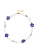 Necklace with stone beads, white beads with blue flowers and statement flowers