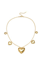 Necklace with beads and different shaped hearts